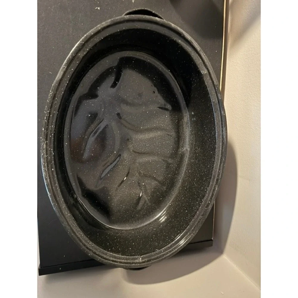 Granite Ware 15-inch oval roaster pan with a lid, speckled black enamel finish.
